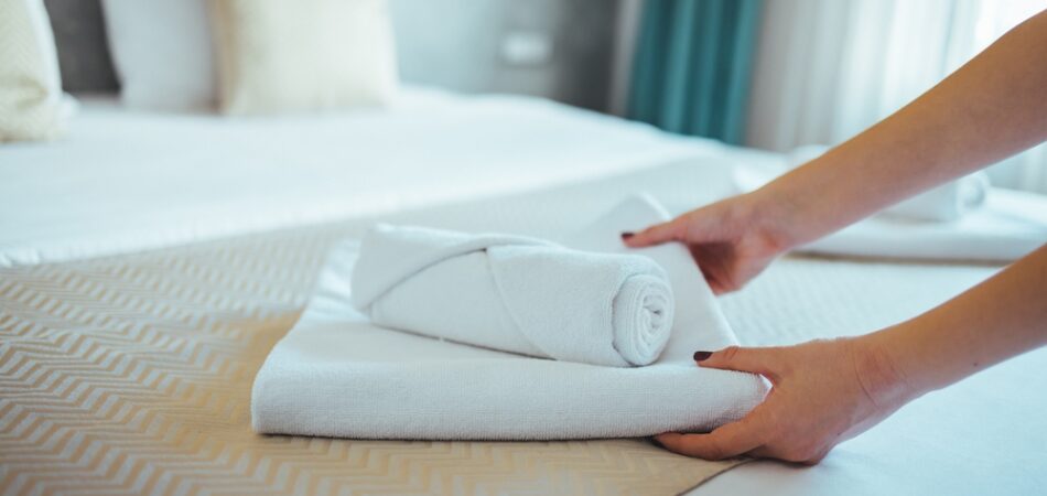 Female,hand,set,up,white,bed,sheet,in,bedroom.,close Up